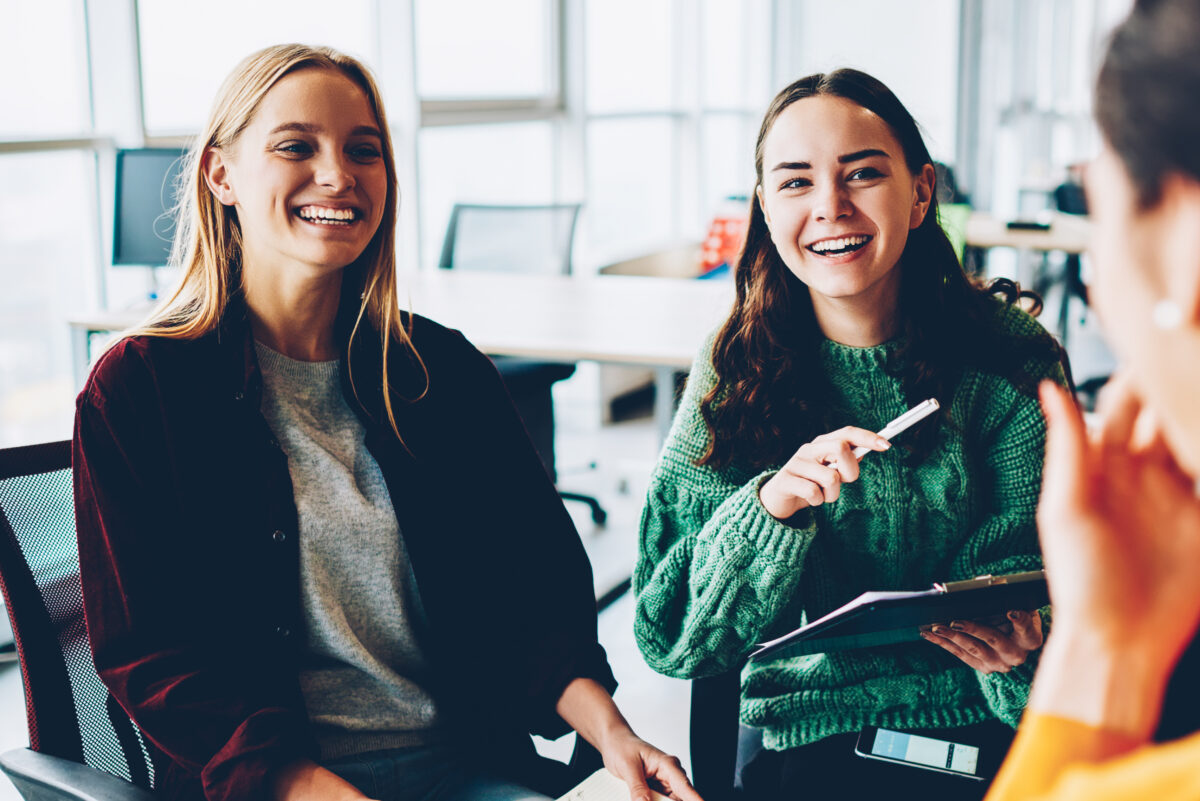 WellMind Therapy - two women smiling and interacting with a friend